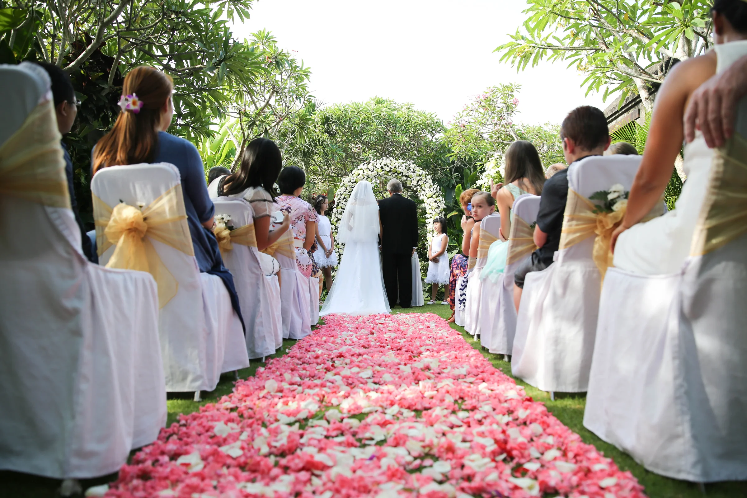 A bride walking through an intimate garden wedding at Mahagiri Villas Sanur